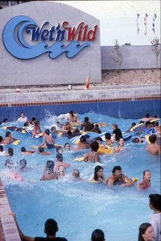 many people are swimming in the pool near a sign that reads, wet n wild