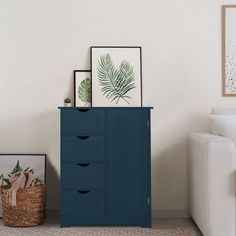 a living room with a white couch and blue cabinet