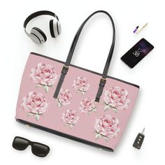 ---------------Welcome to The Giggling Fox-------------------- Cute pink with pink roses vegan PU leather shoulder bag. Made in vegan PU leather. Product is made to order and It is available in 2 sizes.  Please read through this description so you understand the shop policies and what to expect. Here's what you need to know in a nut shell! 100 % High-grade vegan PU leather Gold colored zipper and buckles Available in two seizes  With polyester lining Stylish fit Double sided print  Printed with the best water based pigment inks Ready to ship in 1 - 2 weeks For romantics everywhere this vegan PU leather shoulder bag i a must. Its unique design will make you smile. This high-quality vegan PU leather shoulder bag will elevate your style at school, college, work or out in town. It is perfect f Pink Floral Print Shoulder Bag For Gift, Pink Flower-shaped Shoulder Bag As Gift, Pink Flower-shaped Shoulder Bag For Gifts, Pink Rectangular Shoulder Bag With Cat Design, Pink Floral Print Leather Bag, Bonus Mom Gifts, Laundry Detergent, Stain Remover, Cute Pink