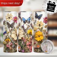 three vases with flowers and butterflies on them