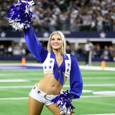 a cheerleader at a football game holding her pom poms