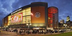 a crowd of people standing outside of a stadium