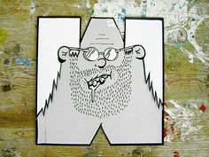 a paper cut out of a man wearing glasses and a beard with rain drops on it