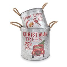 two tin cans with christmas trees and santa's truck painted on the sides, tied together