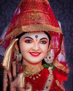 a close up of a statue of a person wearing a red outfit and headdress