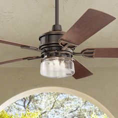 a ceiling fan with a mason jar light hanging from it's center blade on an outdoor patio