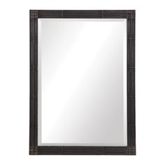 a mirror that is sitting on top of a wall next to a white wall and a black frame