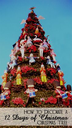 a very tall christmas tree with lots of figurines on it's sides