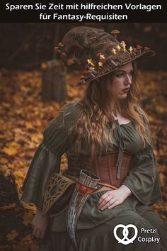 a woman wearing a green dress and hat sitting in the woods with leaves on her head