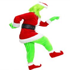 a man dressed as the grinch is dancing in green pants and red santa hat