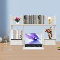 a laptop computer sitting on top of a wooden desk next to a bookshelf