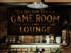 an old fashioned game room sign hangs on the wall in front of a kitchen sink