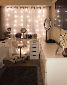 a bedroom with lights on the wall and a desk