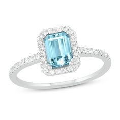 an aqua and white gold ring with diamonds on the sides, set in 18k white gold