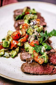 a white plate topped with steak and veggies