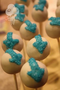 cake pops with blue and white frosting on them