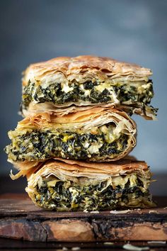 three quesadillas stacked on top of each other with cheese and spinach