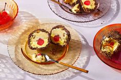 three plates with desserts on them sitting on a table