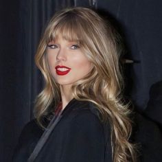 a woman with long blonde hair and red lipstick