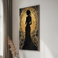 a black and gold art piece hanging on the wall