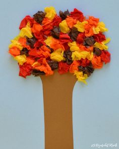 a tree made out of tissue paper with leaves