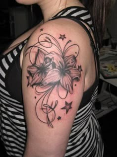 a woman with a flower tattoo on her shoulder