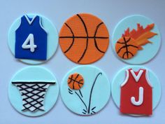 four decorated cookies with different sports designs on them, including basketballs and trees in the hoop