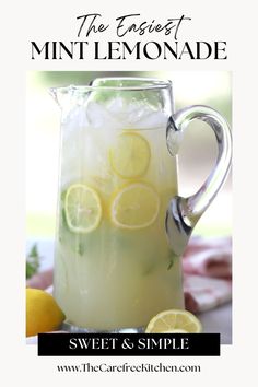 a pitcher filled with lemonade sitting on top of a table