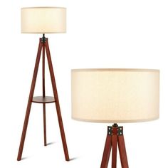 two wooden tripod lamps with white shades on each lamp and one light turned off