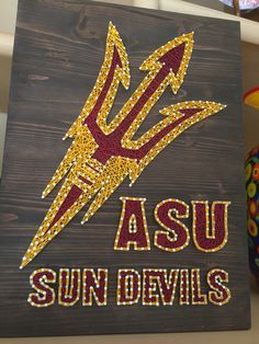 a wooden sign that says asu sun devils