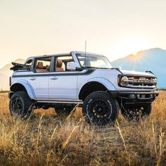 a white truck parked in the middle of a field