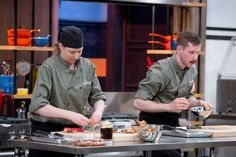 two chefs are preparing food in the kitchen