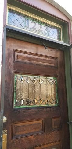 a wooden door with stained glass on it