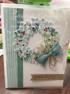 a handmade card with a blue and white wreath on it