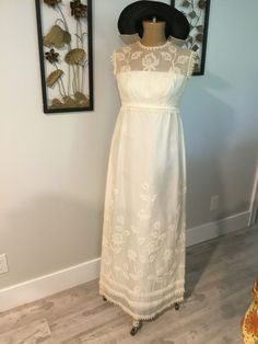 "Off white chiffon or organza maxi. Sweet vintage crochet trim at the armholes, the waist and at hemline. Lovely see through detail on top bodice. The dress has two layers of the chiffon, and an underlayer of a stiffer acetate. There is a lovely embroidered lilly pattern all over the dress. One mini stain on the front, really have to look to see, and some discoloring at neckline. We have done a home dry clean on it, but if you have a trusted cleaner they me able to get it brighter. So it isn't p White Dress Chiffon, Chiffon White Dress, Off White Dress, Off White Dresses, Crochet Vintage, Organza Dress, Dress Chiffon, White Chiffon, Chiffon Maxi