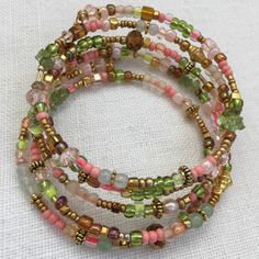 Peach Bronze and Sage Beaded Memory Bracelet Pastel Seed Bead | Etsy Memory Bracelet, Memory Wire Jewelry, Memory Wire Wrap Bracelets, Beaded Memory Wire Bracelets, Beautiful Beaded Bracelet, Green Beaded Bracelets, Preppy Jewelry, Beaded Memory Wire, Memorial Bracelet