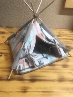 a small teepee tent sitting on top of a wooden table