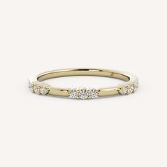 a yellow gold ring with three diamonds