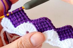 someone is crocheting an object in purple and white