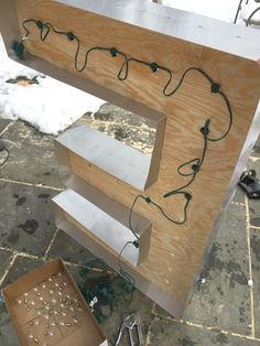 the letters are being made out of plywood and some electrical wires attached to them