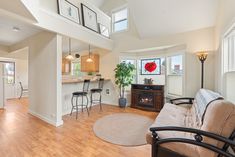 a living room filled with furniture and a fire place in the middle of a kitchen