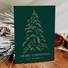 a christmas card on a table with pine cones