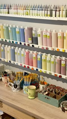 there are many different colors of paint on the shelves in this store that is filled with craft supplies