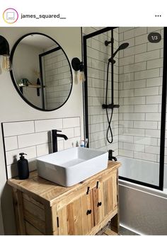 a white sink sitting under a bathroom mirror