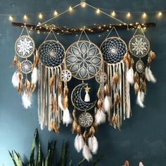 a wall hanging with several dream catchers and lights