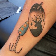 a tattoo on the arm of a person with a fishing hook and fish in it