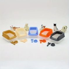 there are many toys that include cats and dogs in this set, including a cat litter box