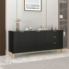 a black and gold sideboard in a living room with a painting on the wall