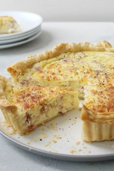 a quiche on a plate with one slice missing