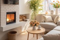 a living room filled with furniture and a fire place next to a tv mounted on a wall